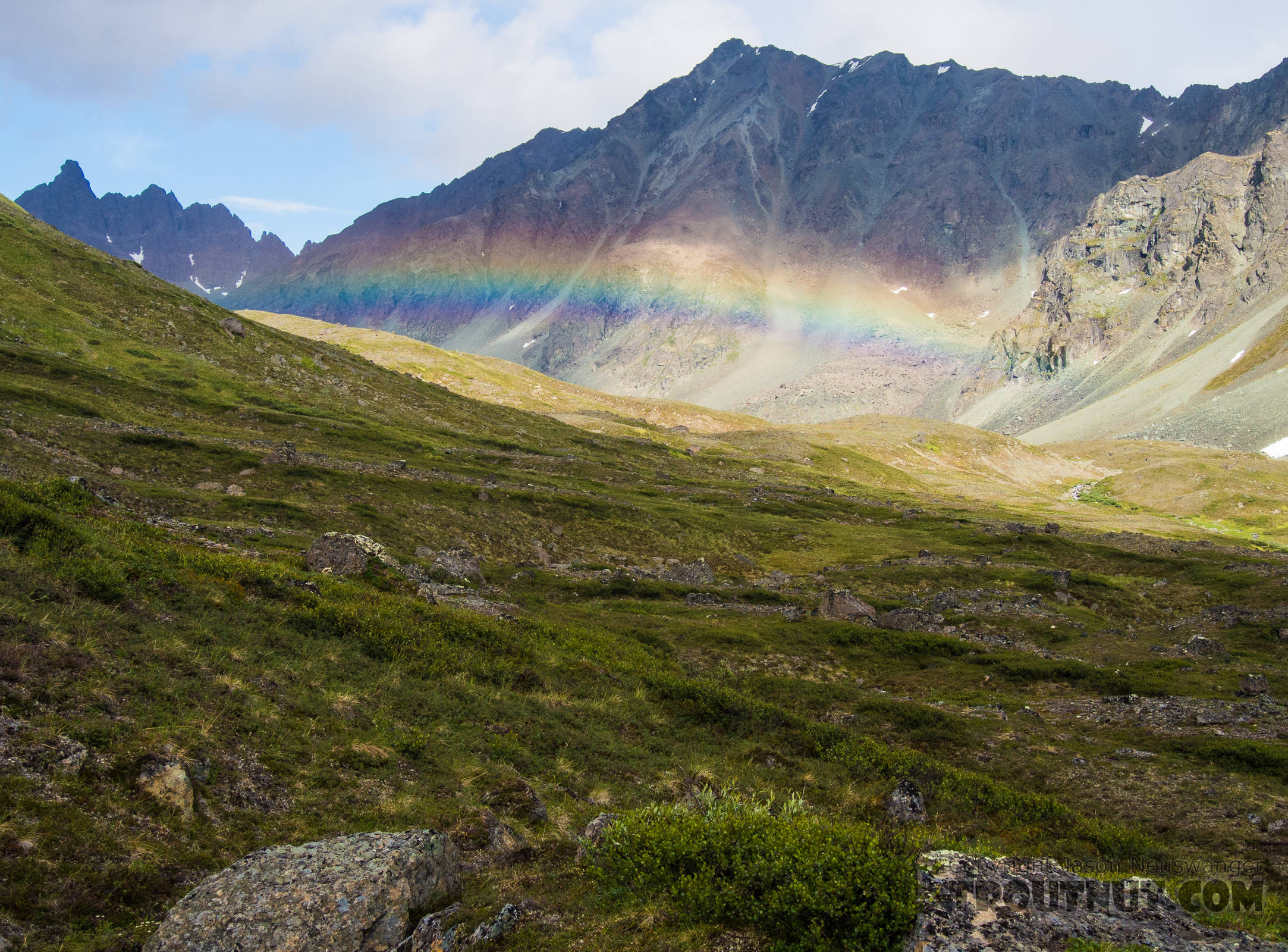 Rainbow over upper Alpine Creek From Clearwater Mountains in Alaska.