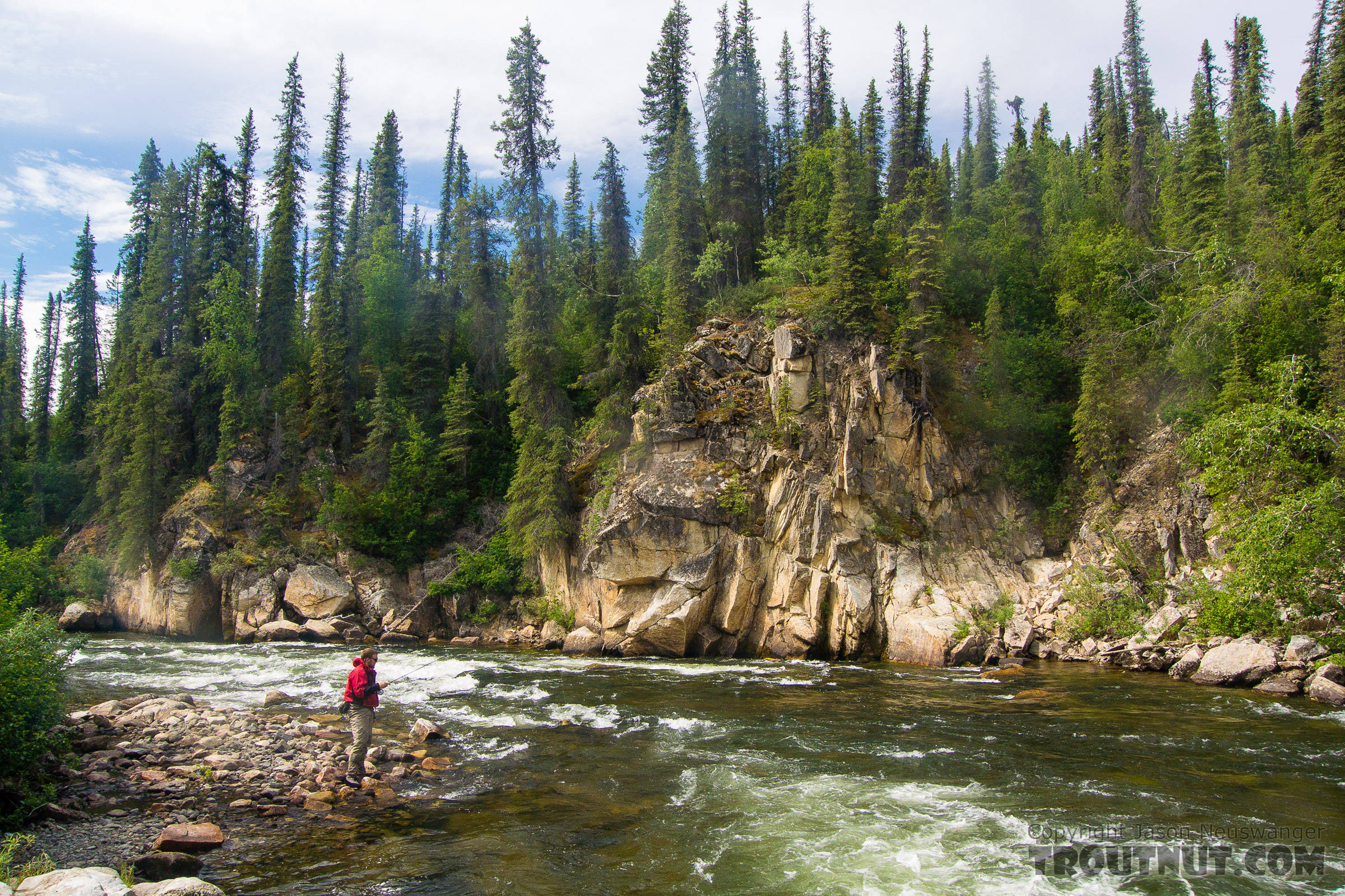 Josh fishing the tail of a big pool in the rapids From the Gulkana River in Alaska.