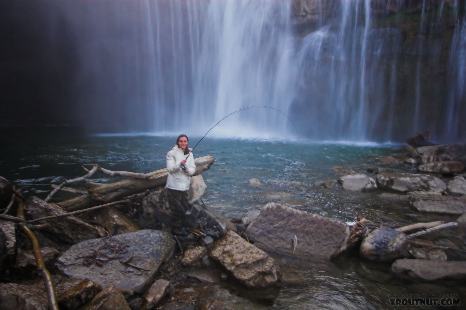 My girlfriend holds her first trout up.  The photo's blurry because the lens is covered with mist from the waterfall. From Salmon Creek, Ludlowville Falls in New York.