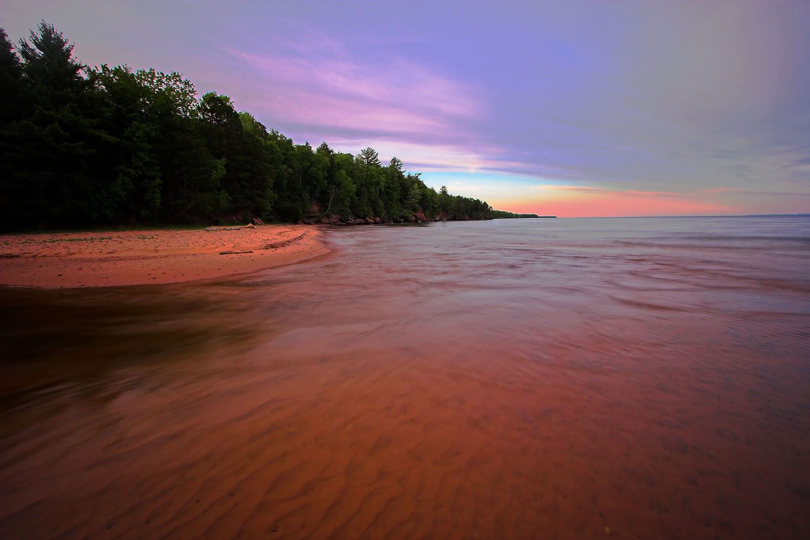 This is the shore of a beautiful island in Lake Superior.  To the left is a narrow channel leading to a a large, shallow bay. From Big Bay on Madeline Island in Lake Superior in Wisconsin.