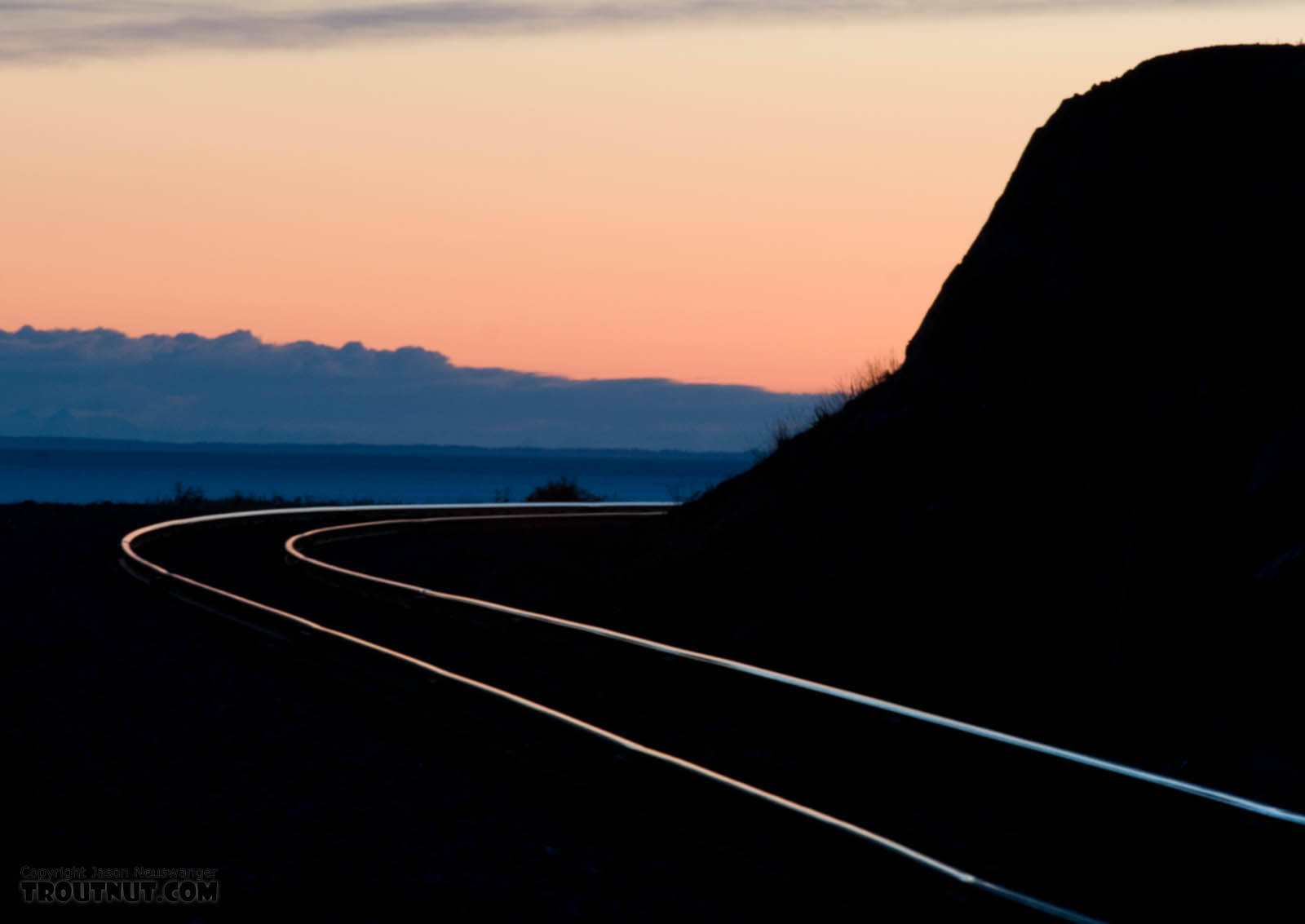 Sunset over the Alaska Railroad tracks along the Turnagain Arm of Cook Inlet, photographed on my drive back home to Fairbanks from the Kenai Peninsula. From Turnagain Arm of Cook Inlet in Alaska.