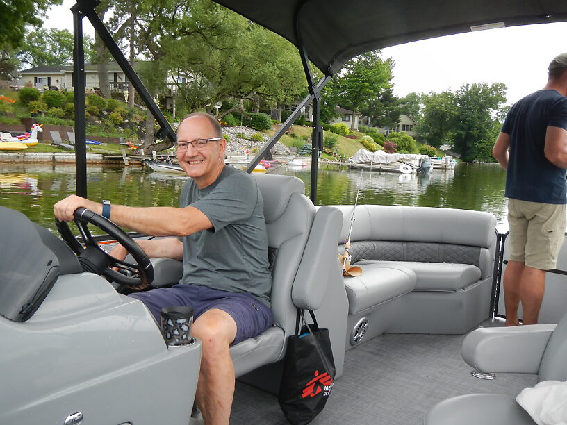 Captain Joe driving his pontoon boat